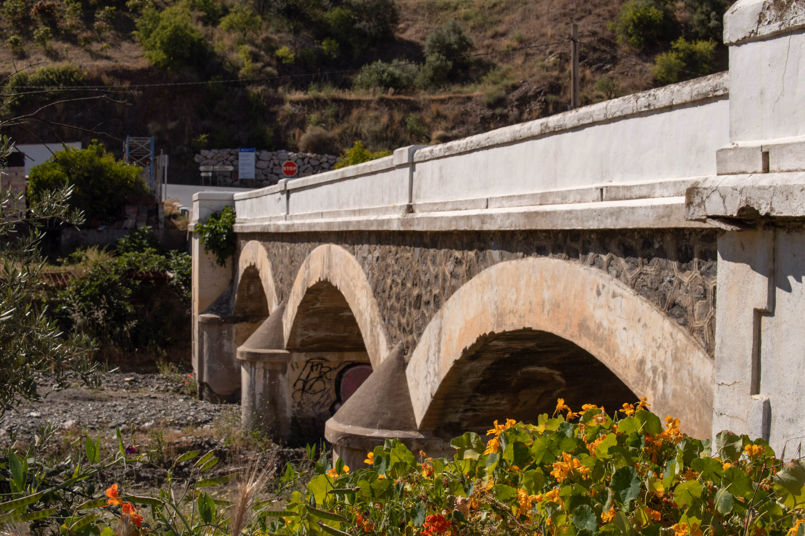 A photograph of a bridge over a dry river bed in Almachar, taken by Jason Elliott for the eastofmalaga.com website.